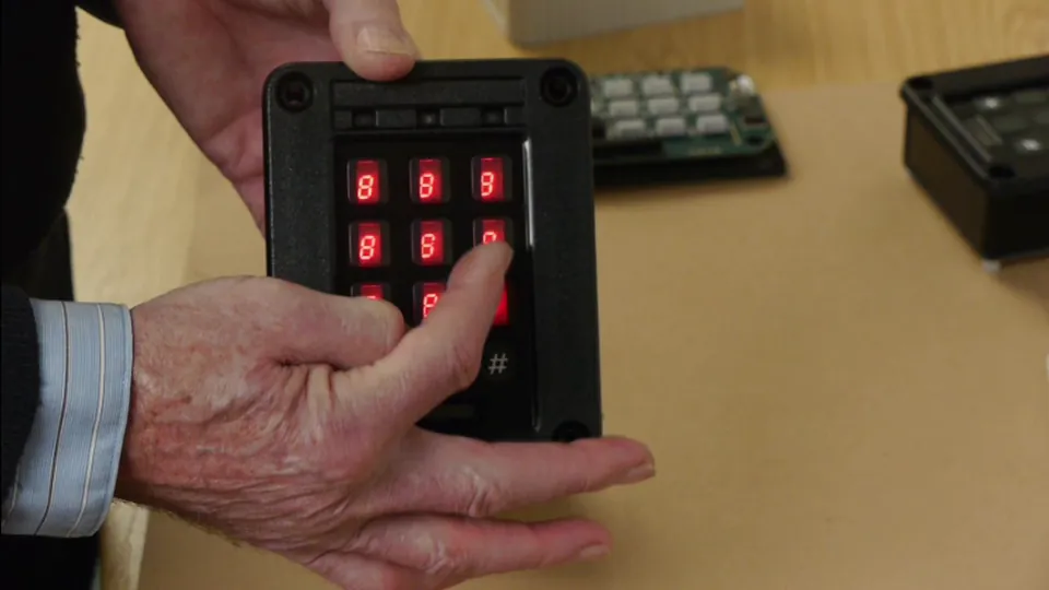 A Codeguard scrambling keypad reassembled in its replacement enclosure, powered up and showing its scrambled digit layout